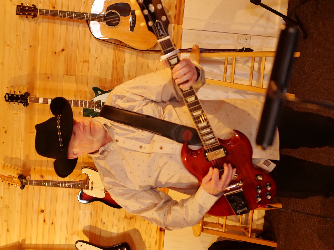 Brent Rougeau with a red Gibson SG and a black cowboy hat